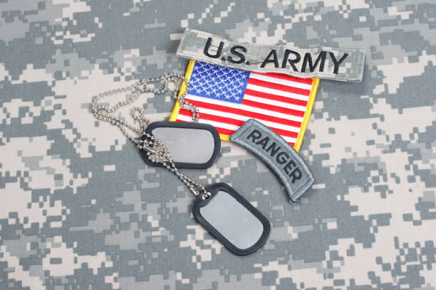 istock US ARMY ranger tab with blank dog tags on camouflage uniform 912648662