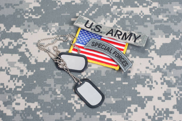 istock US ARMY special forces tab with blank dog tags on camouflage uniform 912649124