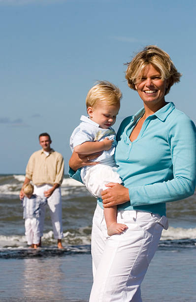 istock happy young family posing on the beach 91265102