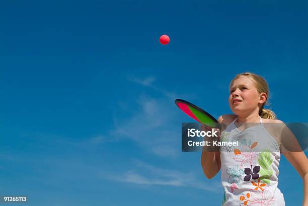 Girl Playing A Ball Game At The Beach Stock Photo - Download Image Now - Active Lifestyle, Activity, Blue