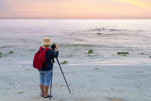 istock Photographer taking a photograph on the beach 912652728