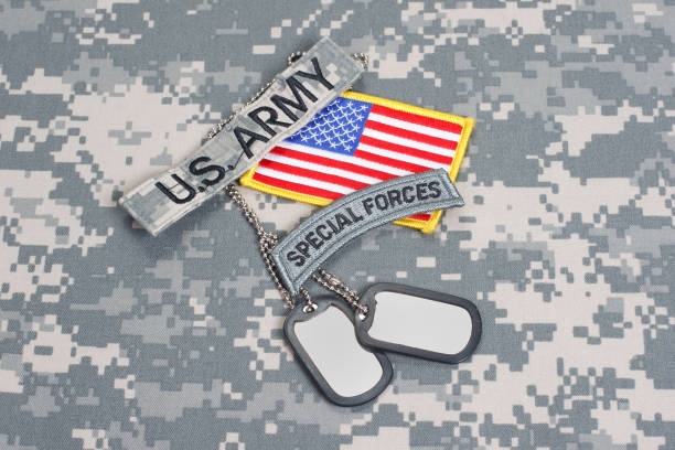 istock US ARMY special forces tab with blank dog tags on camouflage uniform 912652758