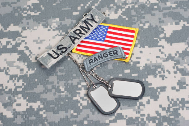 istock US ARMY ranger tab with blank dog tags on camouflage uniform 912655032