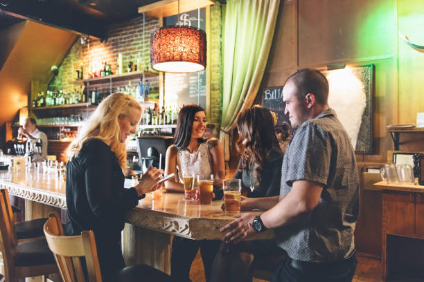 istock Coworkers hanging out in a bar, happy hour time 912657108
