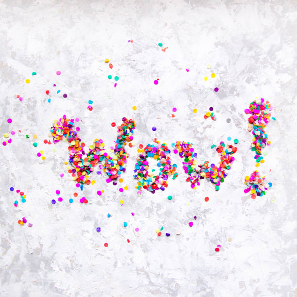 istock Word 'Wow!' made of colorful confetti on white textured background. 912657182