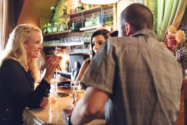 istock Coworkers hanging out in a bar, happy hour time 912657228