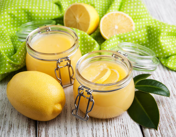 istock Lemon curd in glass jar with fresh lemons 912657348
