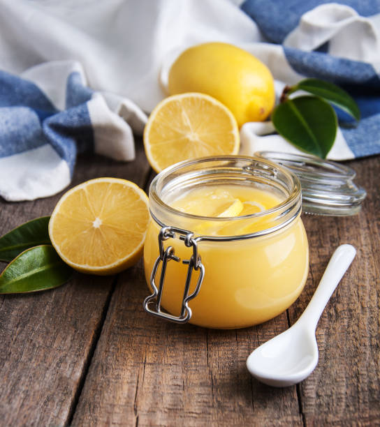 istock Lemon curd in glass jar with fresh lemons 912657632