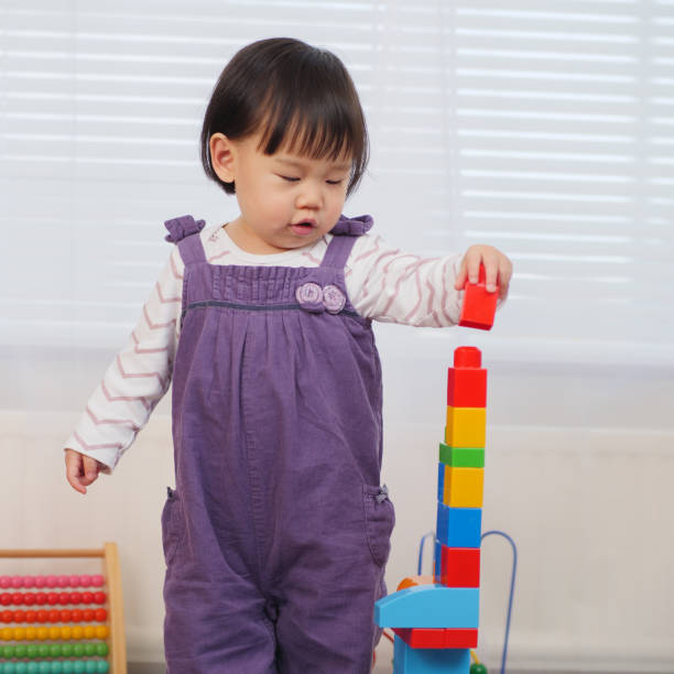 istock Baby Girl Playing With Toy Blocks 912658760