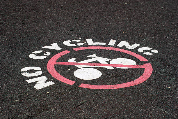 No Cycling stamped on tar stock photo