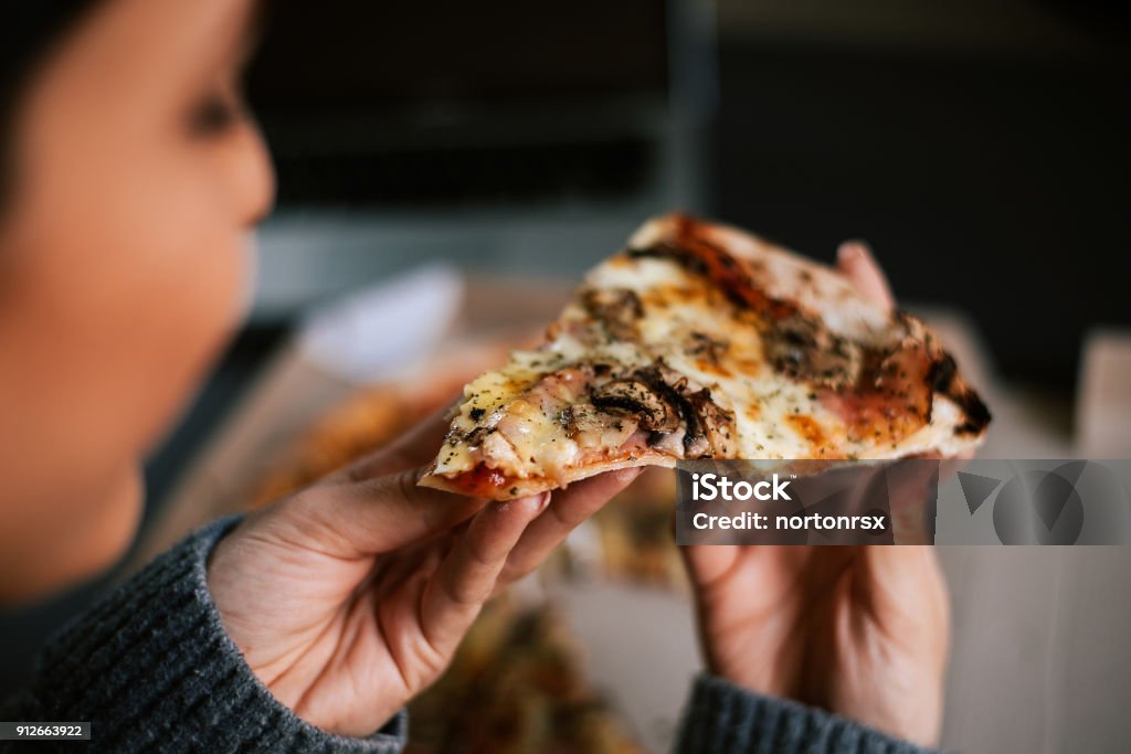 Eating pizza at night. Close-up Eating Stock Photo