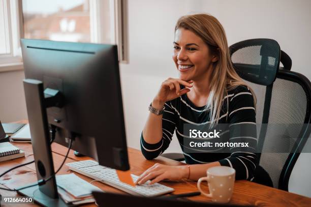 Smiling Blonde Business Woman Working At Office Desk Stock Photo - Download Image Now