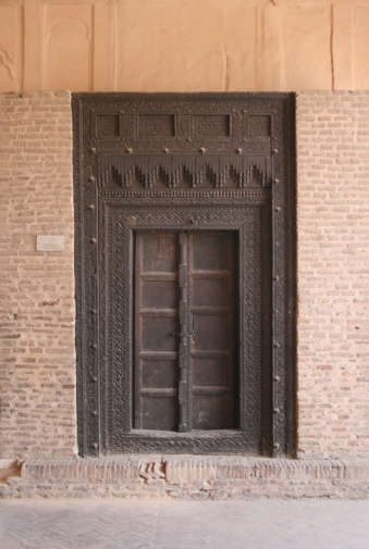 A closeup of a medieval-style old wooden door