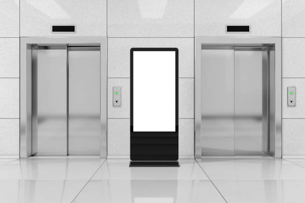Blank Trade Show LCD Screen Stand as Template for Your Design near Modern Elevator or Lift with Metal Doors in Office Building. 3d Rendering