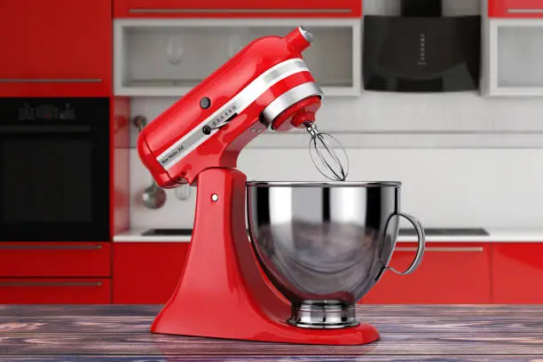 Red Kitchen Stand Food Mixer on a wooden table. 3d Rendering