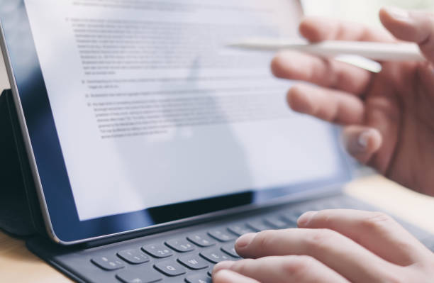 istock Blogger working mobile touchpad for work.Closeup view of male hands typing electronic tablet keyboard-dock station and using stylus pen.Horizontal.Blurred background. 912675152