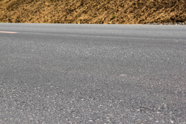 istock Gray asphalt closeup, roadside sand 912681036