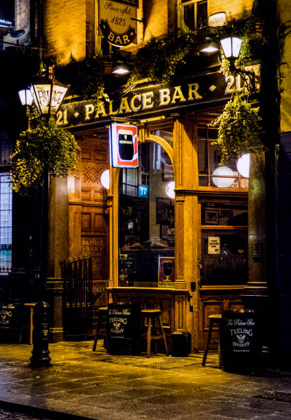 A friendly glow Dublin, Ireland - January 16, 2018: A warm glow greets the customers outside this famous Dublin pub. irish punt note stock pictures, royalty-free photos & images