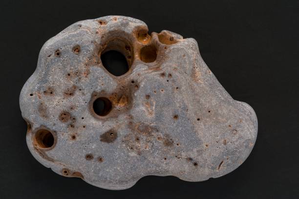 closeup of one isolated stone of an abstract form on a black background