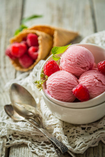 istock Raspberry ice cream in white bowl, rustic wood background 912688508