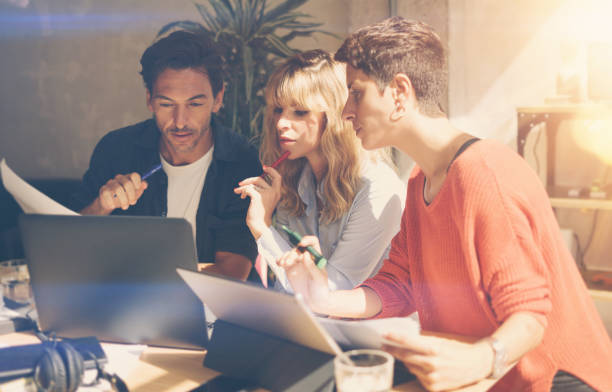 istock Group of coworkers making great conversation during work process in modern office.Business people meeting concept.Blurred background.Horizontal. 912688676