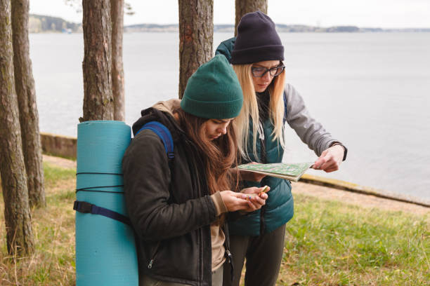 istock Two young tourist determine the route map and compass. 912688992