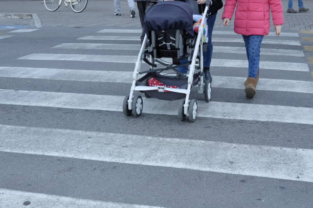 istock mom crosses on zebra crossing with the stroller 912689036