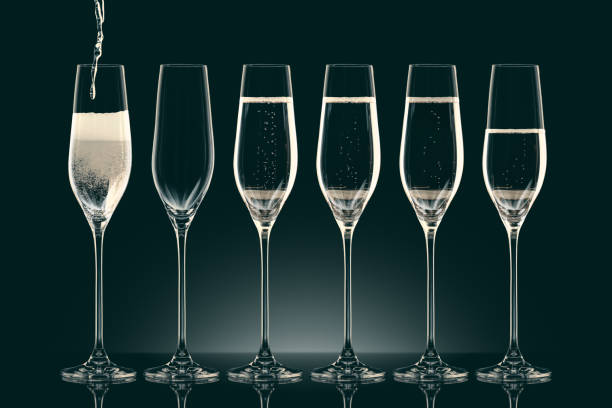 istock pouring champagne into six transparent glasses on black 912690064