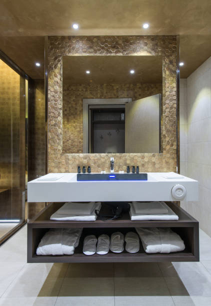 istock Big luxury mirror in bathroom interior, and towels on shelf 912690216