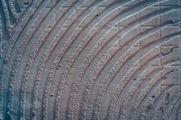 Curved lines from tile glue on the wall, texture, background