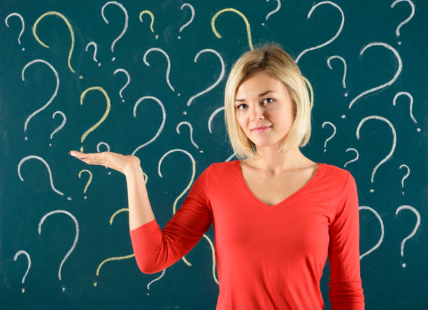 istock Pensive Woman in front of blackboard with question mark 912693108