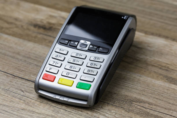 istock payment terminal isolated on wooden background 912693848