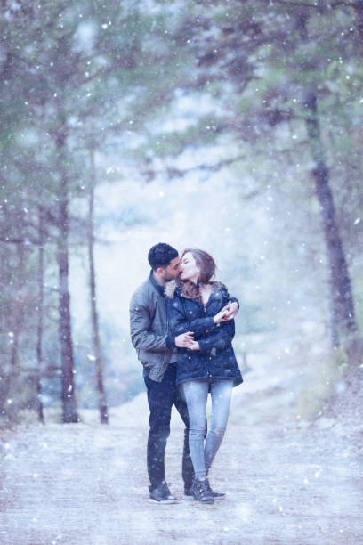 istock Young happy couple in winter forest 912696014