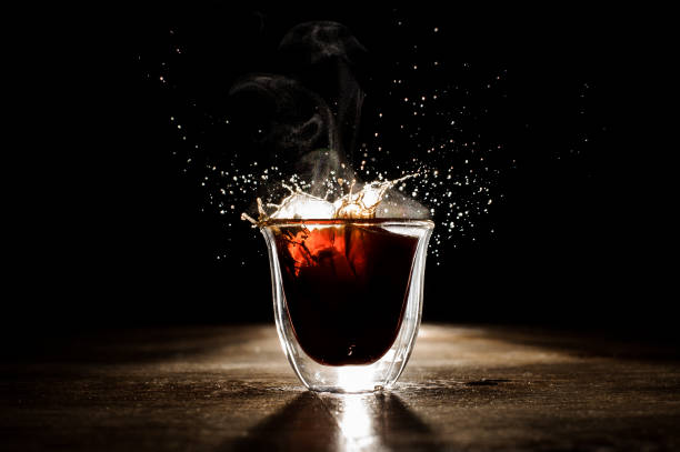 istock Hot and aromatic coffee spilling from transparent glass cup 912699966
