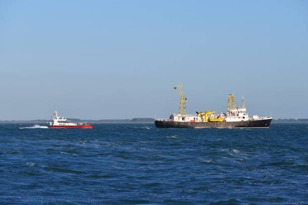 istock Pilot ship leading cargo ship to port 912700592