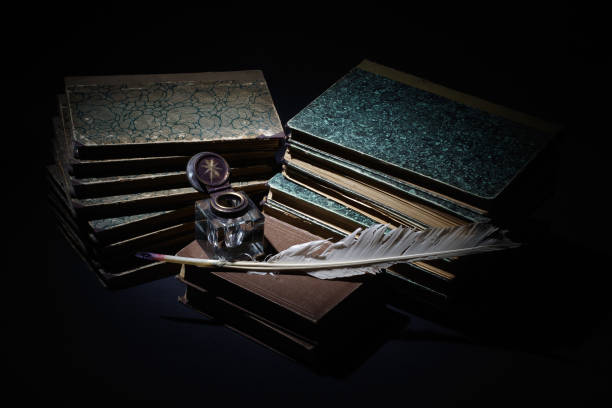 istock old books, papers, ink pen and inkpot on black background 912702180