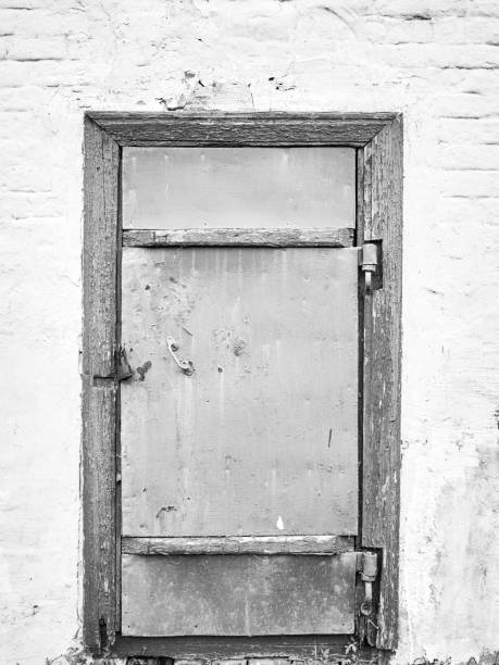 istock Closed gray door in old brick white wall 912704492