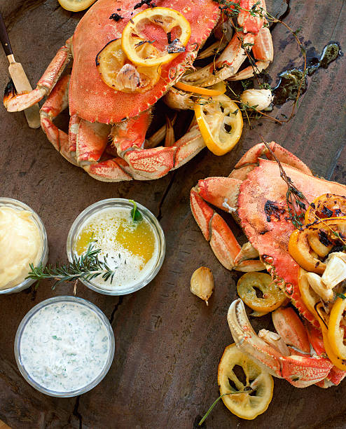 Fire roasted dungeness crabs on wooden table  crab seafood stock pictures, royalty-free photos & images