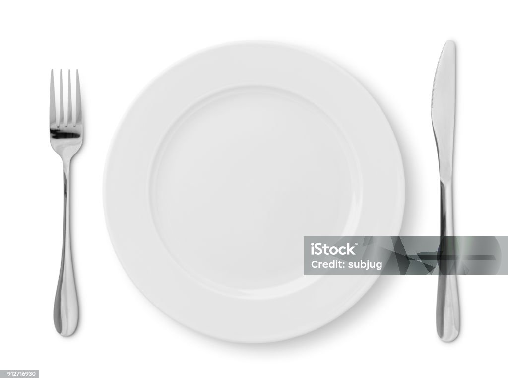 Place Setting Simple table place setting - plate, fork and knife isolated on white (excluding the shadow) Empty Plate Stock Photo