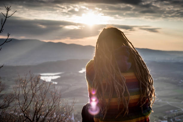 istock Young Rastafarian Man Enjoying the View on Sunset in Nature 912722982