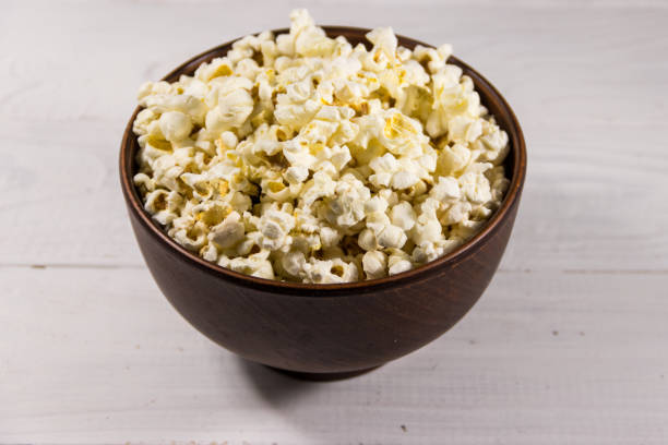 istock Bowl with popcorn on wooden table 912723362