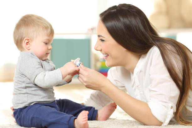 istock Proud mother giving a pacifier to her baby 912728028