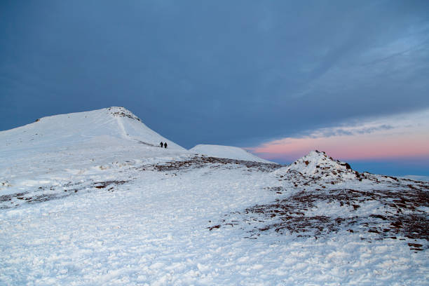 Landscape of Pen y Fan Mountain with winter snow at sunset.