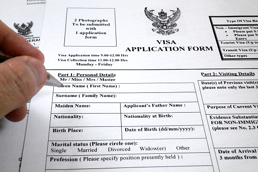 Bangkok, Thailand - April 23 2017: Somebody filling a visa application form to travel to Thailand.