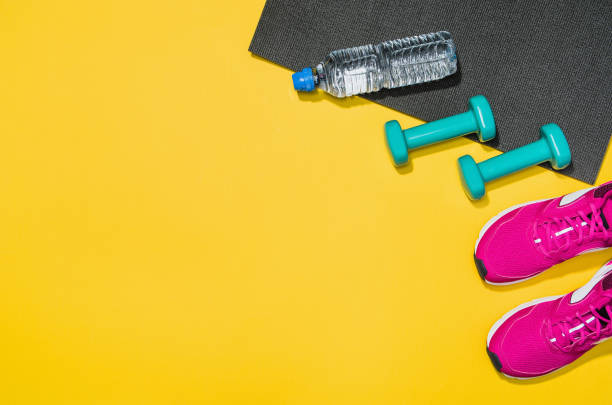 istock Fitness accessories on yellow background mock up, top view 912733620