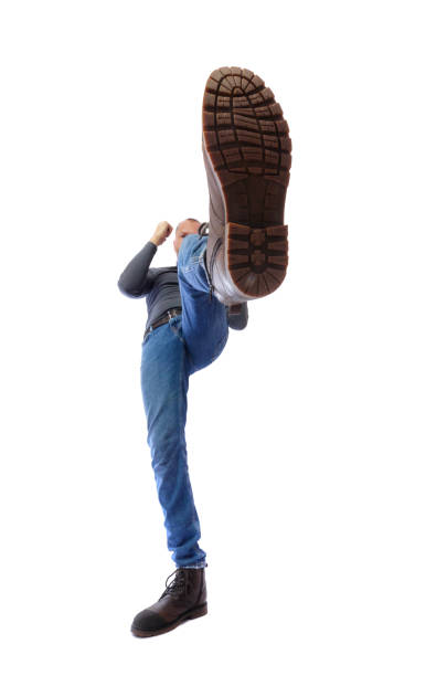 istock The man is kicking. Foot with a shoe close-up. Fun kick fights w 912733708