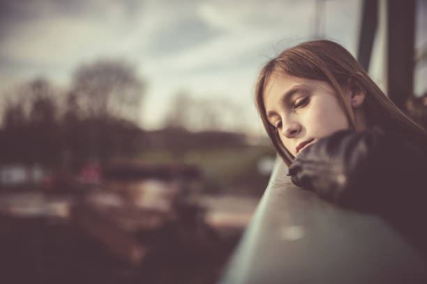 Young girl thinking over something outdoors