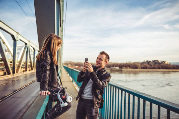 istock Father and daughter taking photos on the bridge 912734602