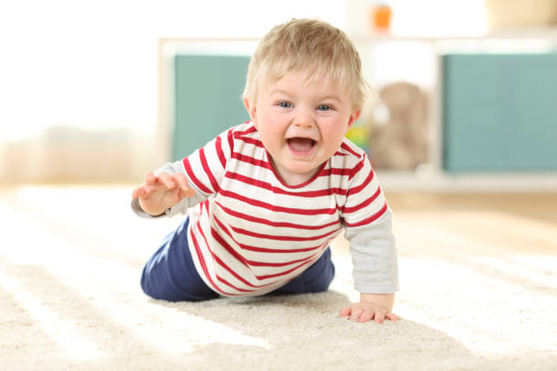 istock Joyful baby crawling towards camera 912734660