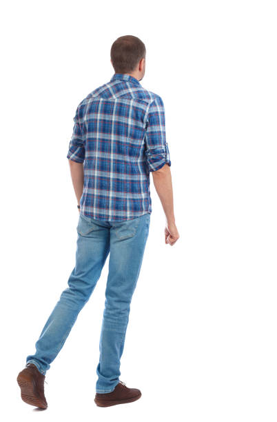 istock Back view of going  handsome man. walking young guy . 912734874